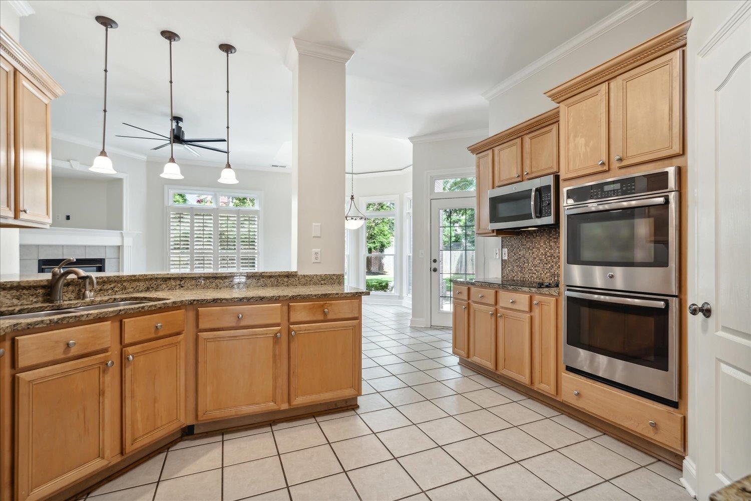 9128 Raspberry Lane Cordova, TN 38016 - Photo 7 of 32 a kitchen with stainless steel appliances granite countertop a stove a sink and a refrigerator