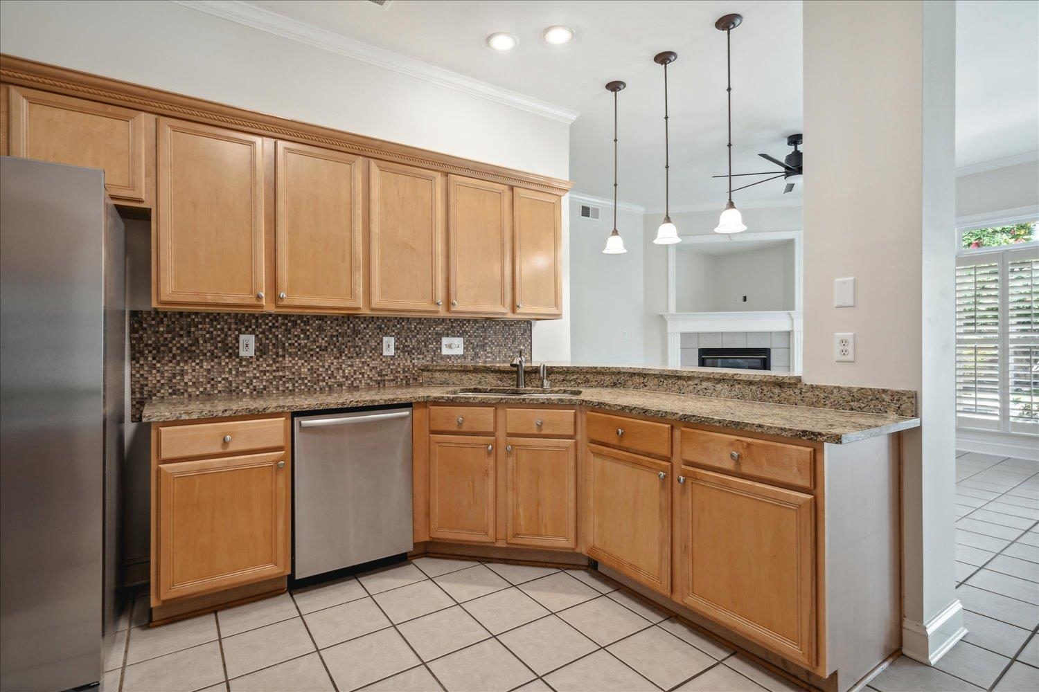 9128 Raspberry Lane Cordova, TN 38016 - Photo 8 of 32 a kitchen with stainless steel appliances granite countertop a stove a sink and a refrigerator