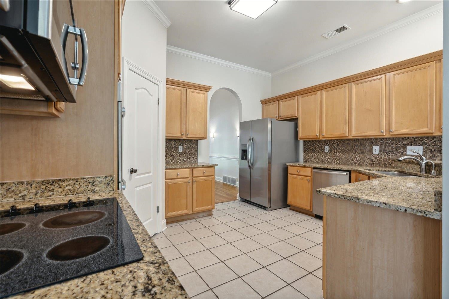 9128 Raspberry Lane Cordova, TN 38016 - Photo 10 of 32 a kitchen with stainless steel appliances granite countertop a sink stove and refrigerator