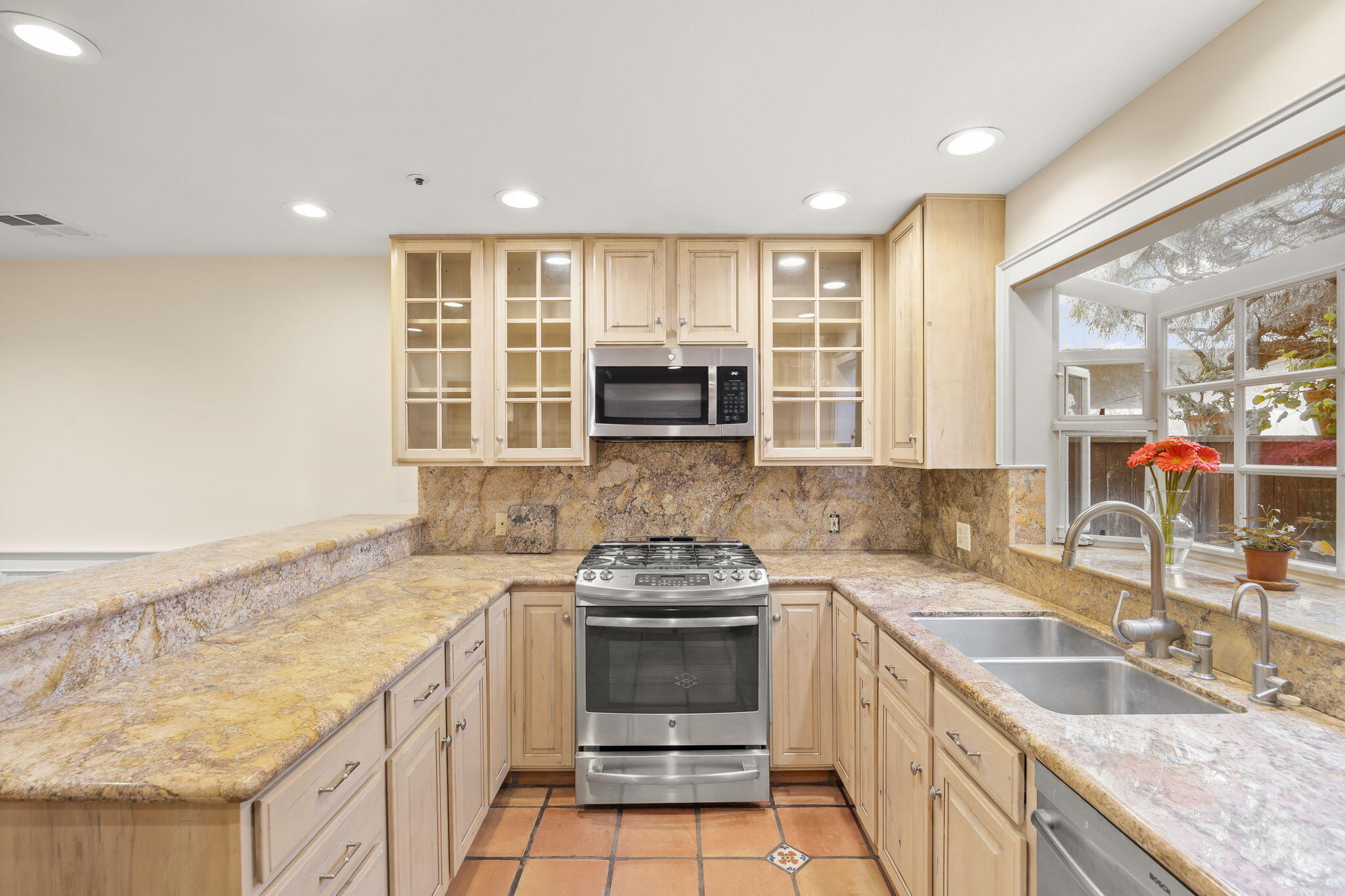 4228 Carpinteria Avenue, Unit 2 Carpinteria, CA 93013 - Photo 12 of 32 a kitchen with granite countertop a sink stove and cabinets