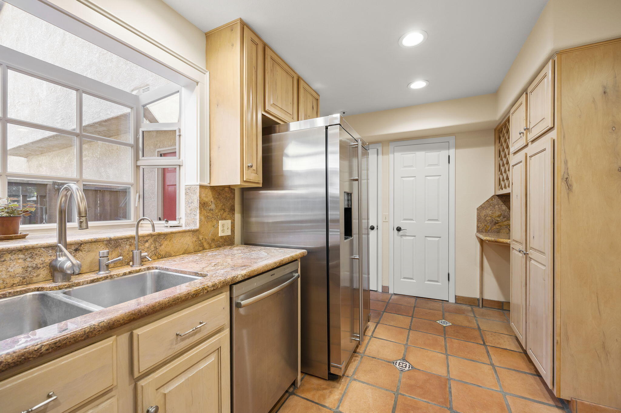 4228 Carpinteria Avenue, Unit 2 Carpinteria, CA 93013 - Photo 16 of 32 a kitchen with stainless steel appliances granite countertop a refrigerator and a sink