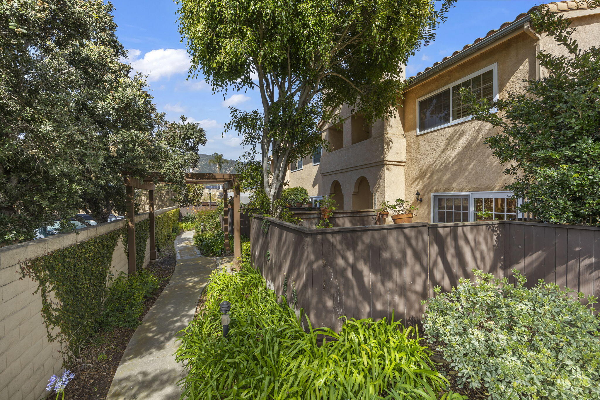 4228 Carpinteria Avenue, Unit 2 Carpinteria, CA 93013 - Photo 2 of 32 a backyard of a house with lots of green space