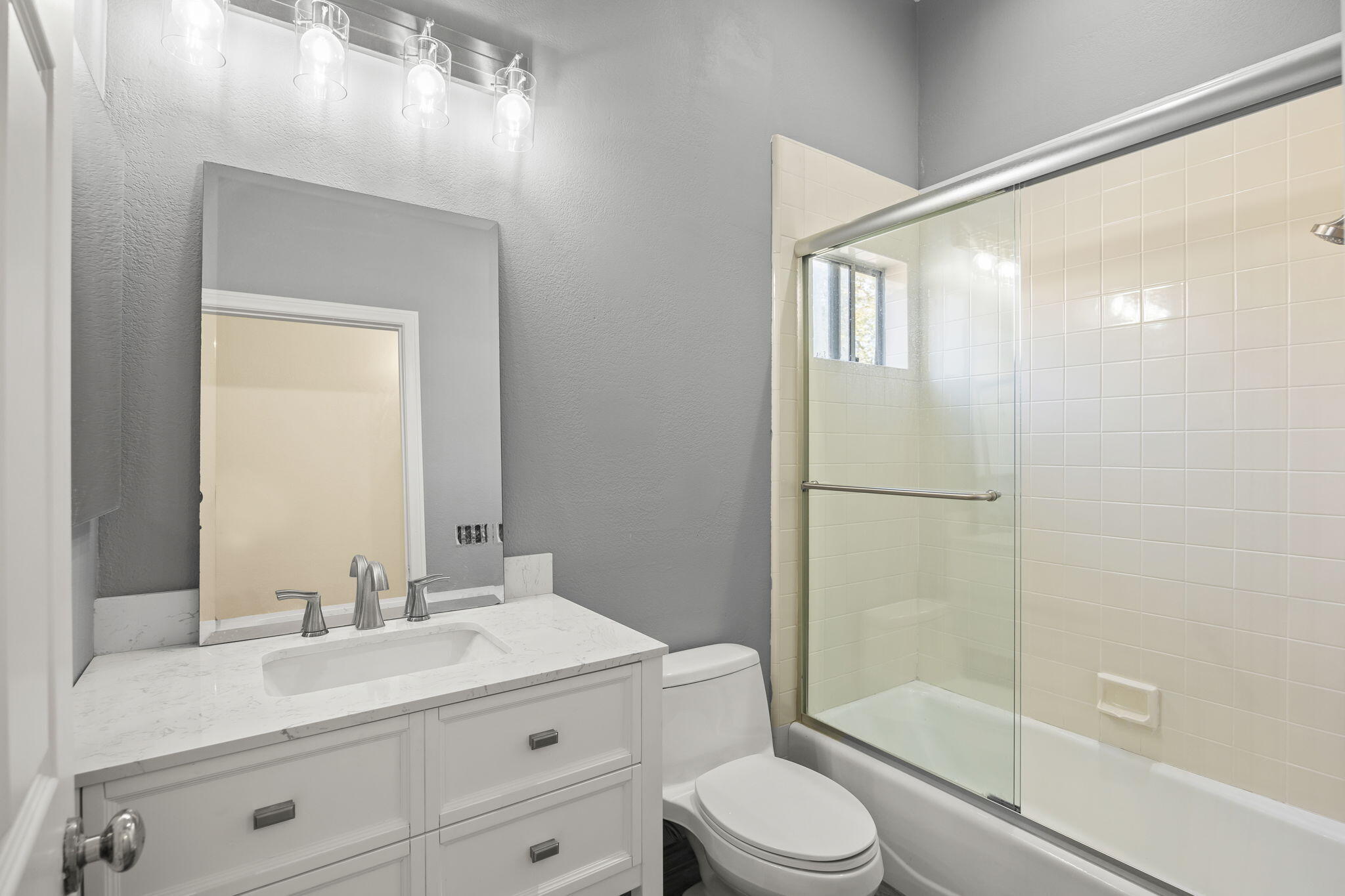 4228 Carpinteria Avenue, Unit 2 Carpinteria, CA 93013 - Photo 21 of 32 a bathroom with a double vanity sink toilet mirror and shower