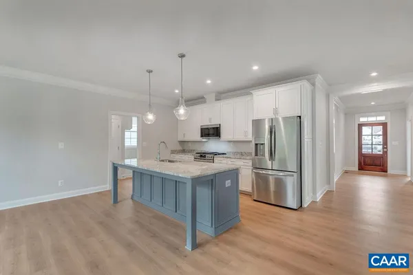 a kitchen with a sink and a hard wood floor