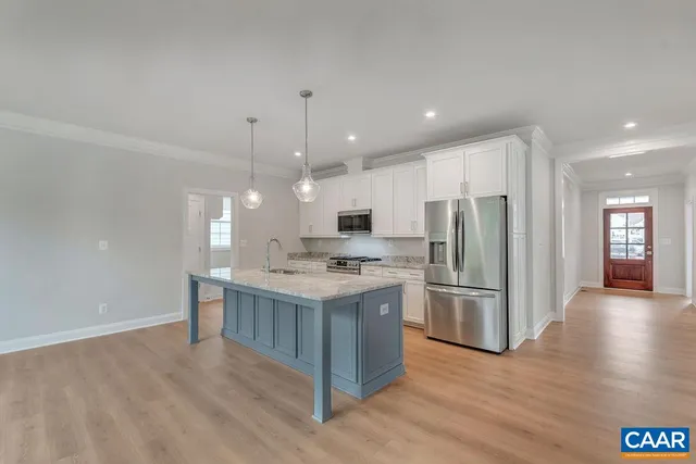 a kitchen with a sink and a hard wood floor