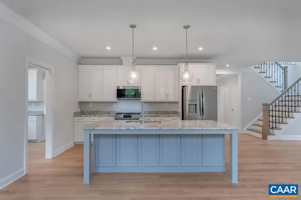 a view of a kitchen with a sink and chandelier