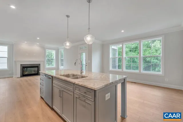 a kitchen with white cabinets and window