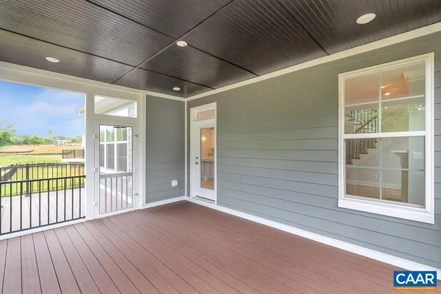 a view of a balcony with floor to ceiling window and wooden fence