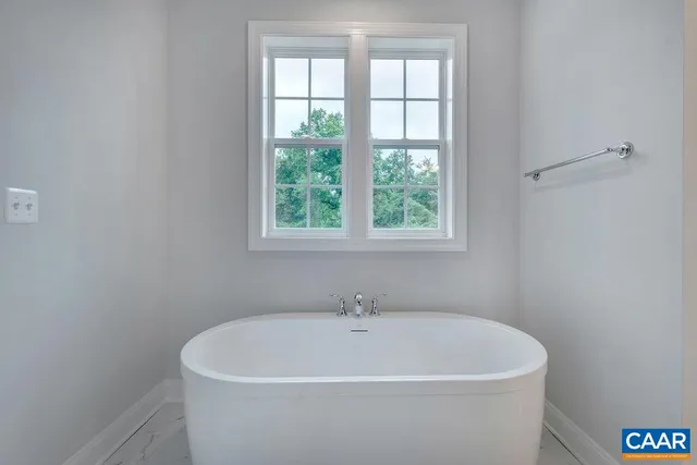 a bathroom with a bathtub and shower