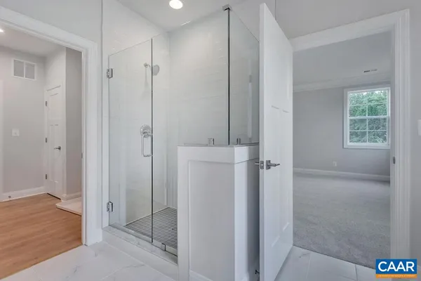 a bathroom with a shower a sink and a mirror