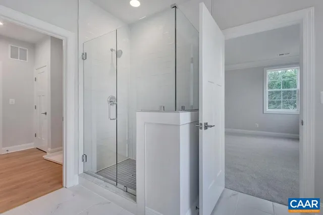 a bathroom with a shower a sink and a mirror