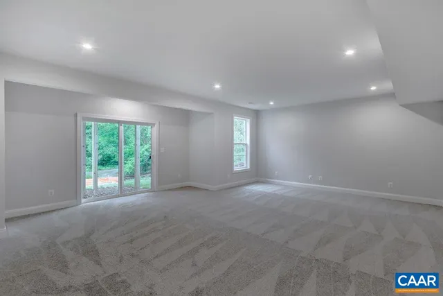 a view of a house with backyard and wooden fence