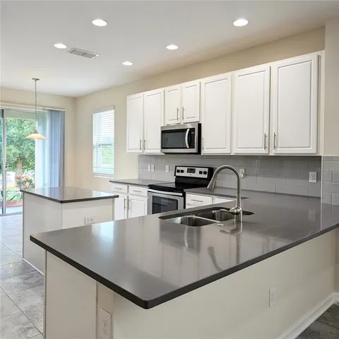 a kitchen with a sink stove and refrigerator