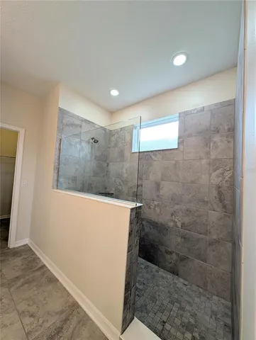 a bathroom with a granite countertop toilet sink and mirror