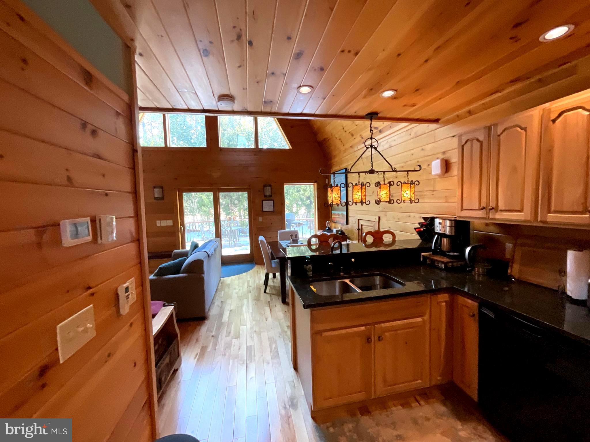 4839 Graces Cabin Road Romney, WV 26757 - Photo 3 of 26 a kitchen with granite countertop a stove a sink dishwasher and cabinets with wooden floor