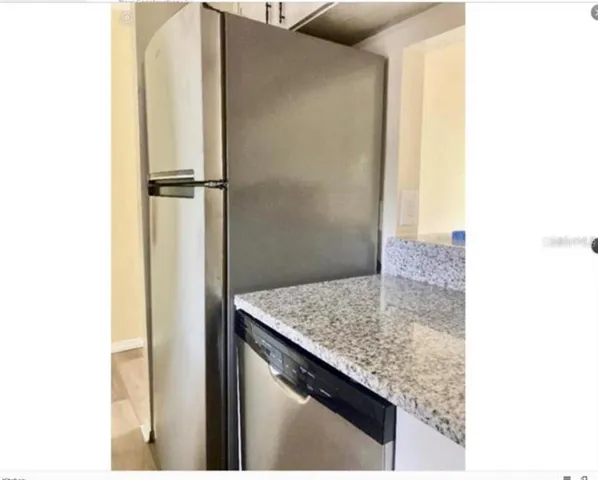 a bathroom with a granite countertop sink and mirror