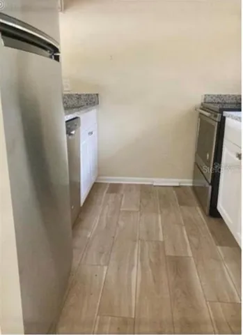 a view of a hardwood & utility room