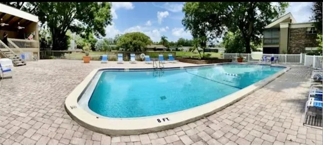 swimming pool view with a outdoor seating