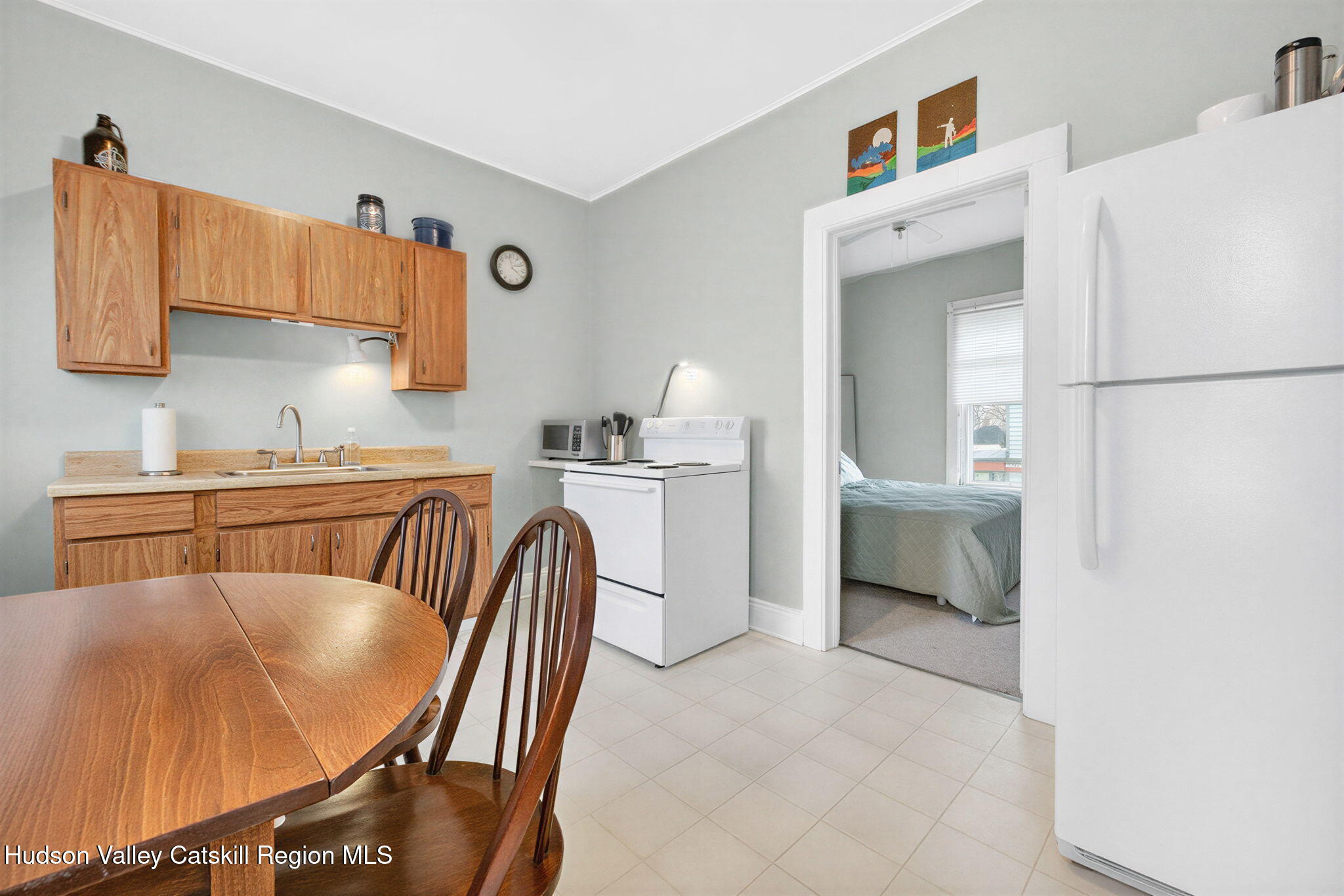 13 South Franklin Street, Unit 3 Athens, NY 12015 - Photo 14 of 55 a kitchen with a table chairs and a refrigerator