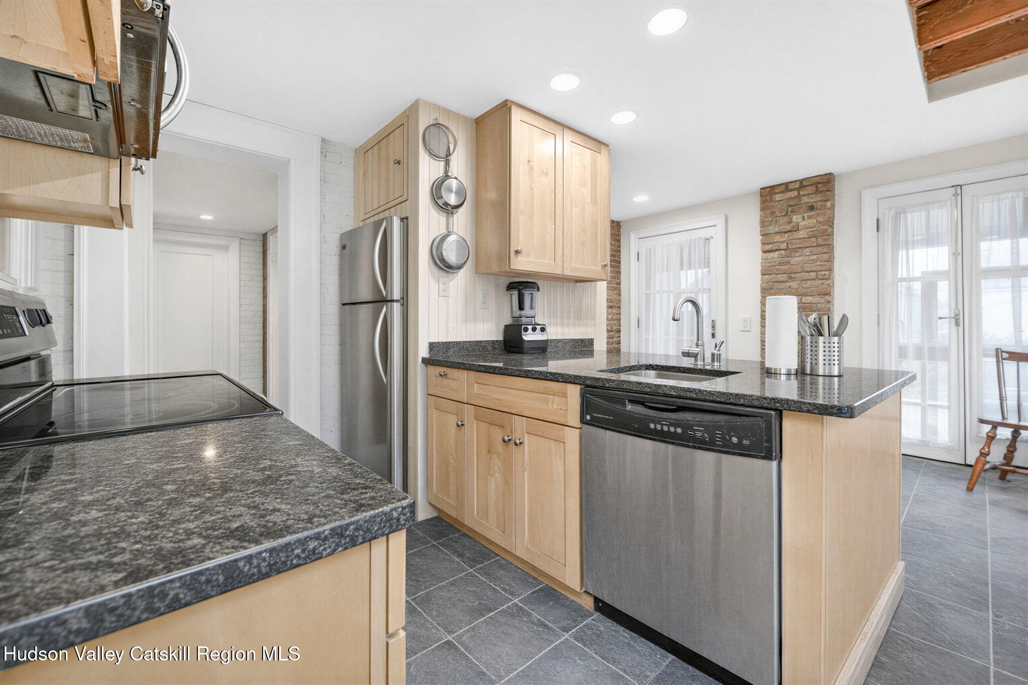 13 South Franklin Street, Unit 3 Athens, NY 12015 - Photo 22 of 55 a kitchen with stainless steel appliances granite countertop a sink and a refrigerator