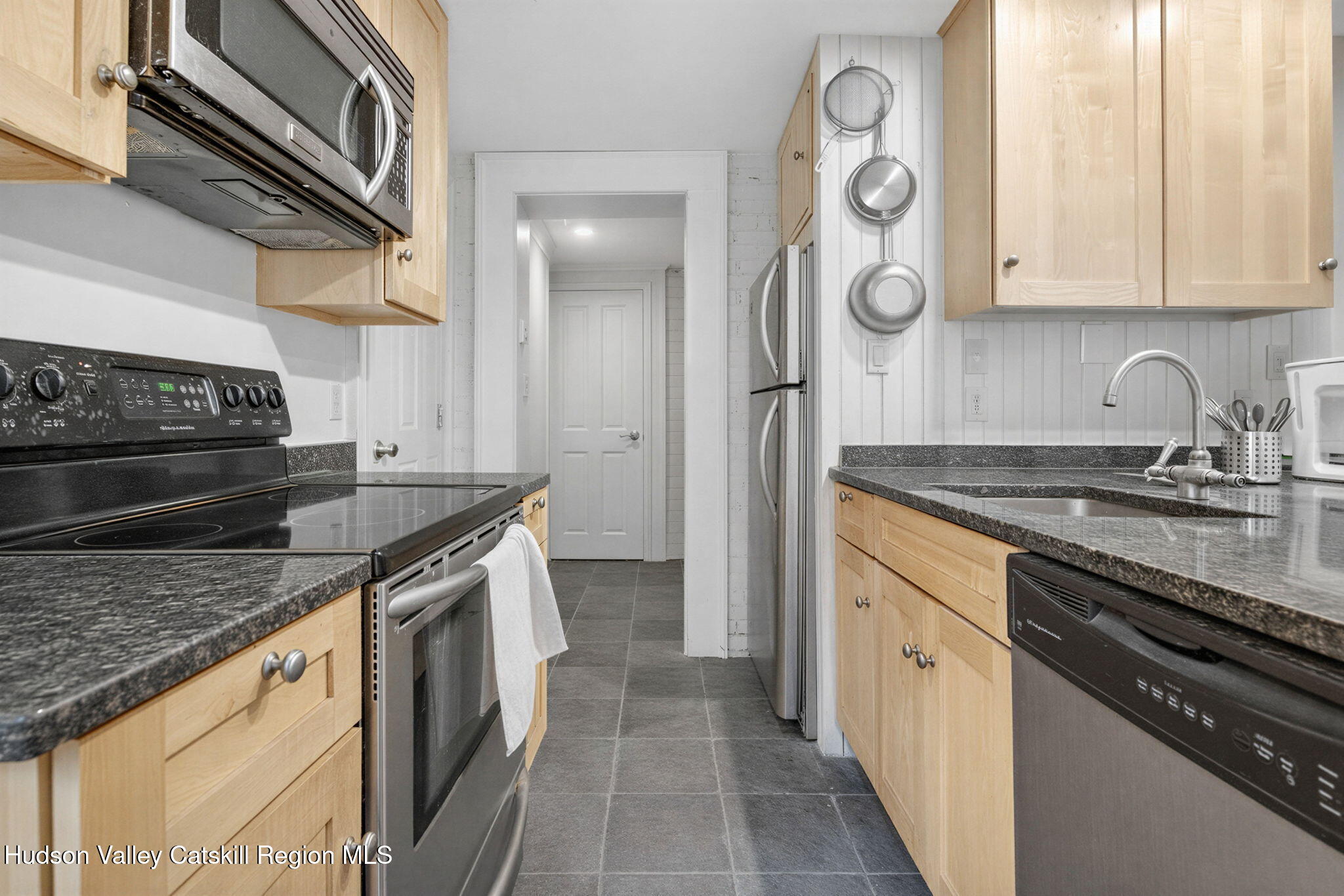 13 South Franklin Street, Unit 3 Athens, NY 12015 - Photo 23 of 55 a kitchen with stainless steel appliances granite countertop a sink and a stove