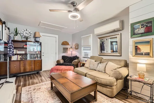a living room with furniture ceiling fan and a rug