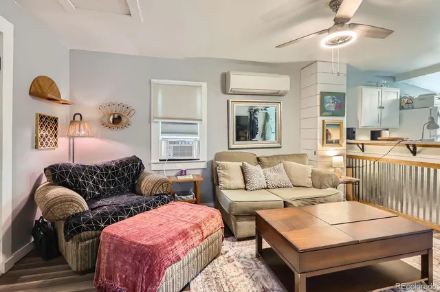a living room with furniture rug and window