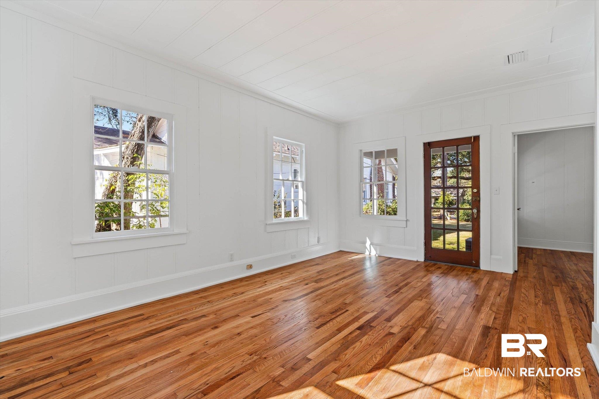 2153 Old Government Street Mobile, AL 36606 - Photo 13 of 23 Spare room with hardwood / wood-style floors and a decorative wall