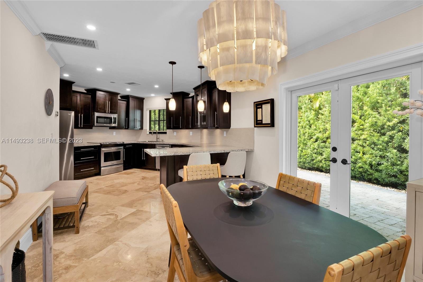 605 Blue Road Coral Gables, FL 33146 - Photo 14 of 34 a dining room with furniture and chandelier