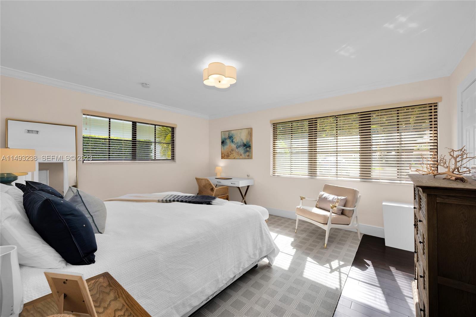 605 Blue Road Coral Gables, FL 33146 - Photo 18 of 34 a bedroom with a bed a table and a large window