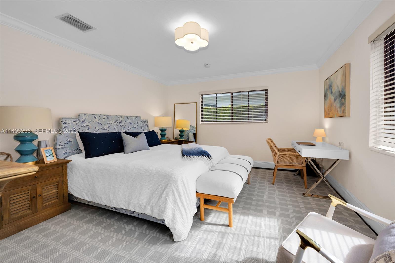 605 Blue Road Coral Gables, FL 33146 - Photo 19 of 34 a bedroom with a bed window and a table