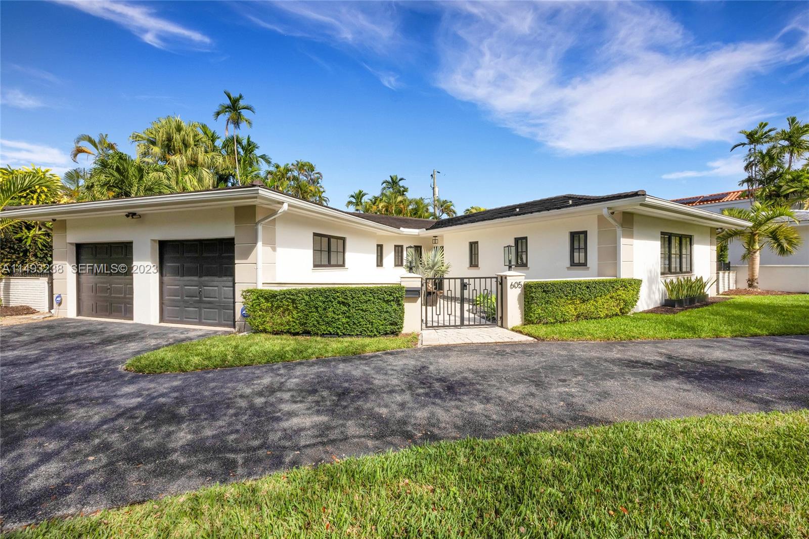 605 Blue Road Coral Gables, FL 33146 - Photo 2 of 34 a front view of a house with a garden and porch