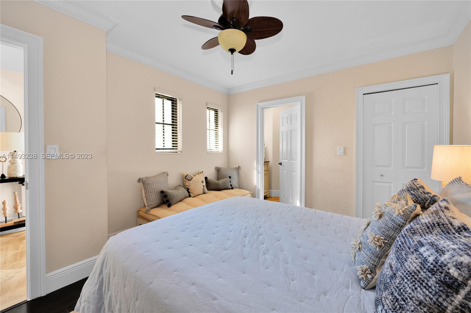 605 Blue Road Coral Gables, FL 33146 - Photo 24 of 34 a bedroom with a bed and a chandelier
