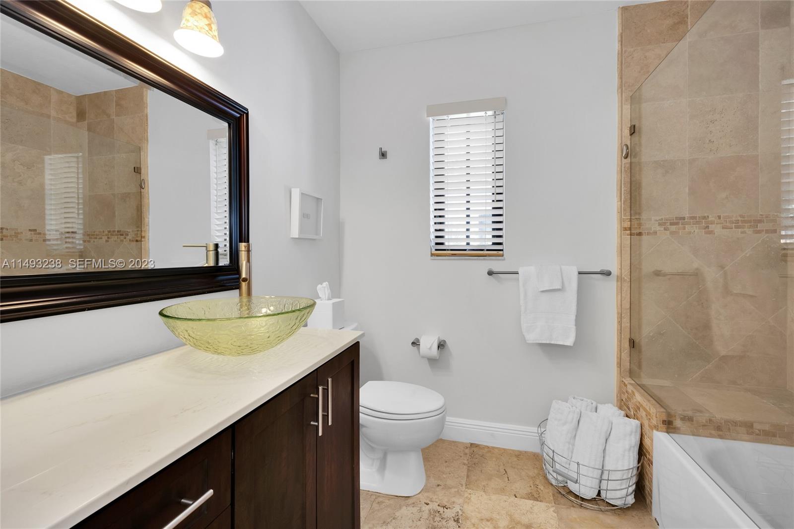 605 Blue Road Coral Gables, FL 33146 - Photo 27 of 34 a bathroom with a granite countertop sink toilet and shower