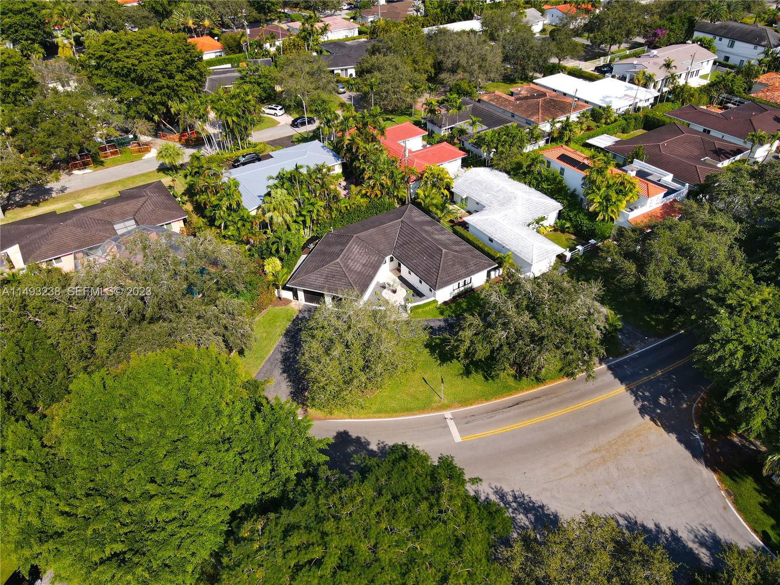 605 Blue Road Coral Gables, FL 33146 - Photo 30 of 34 an aerial view of residential houses with outdoor space and trees all around