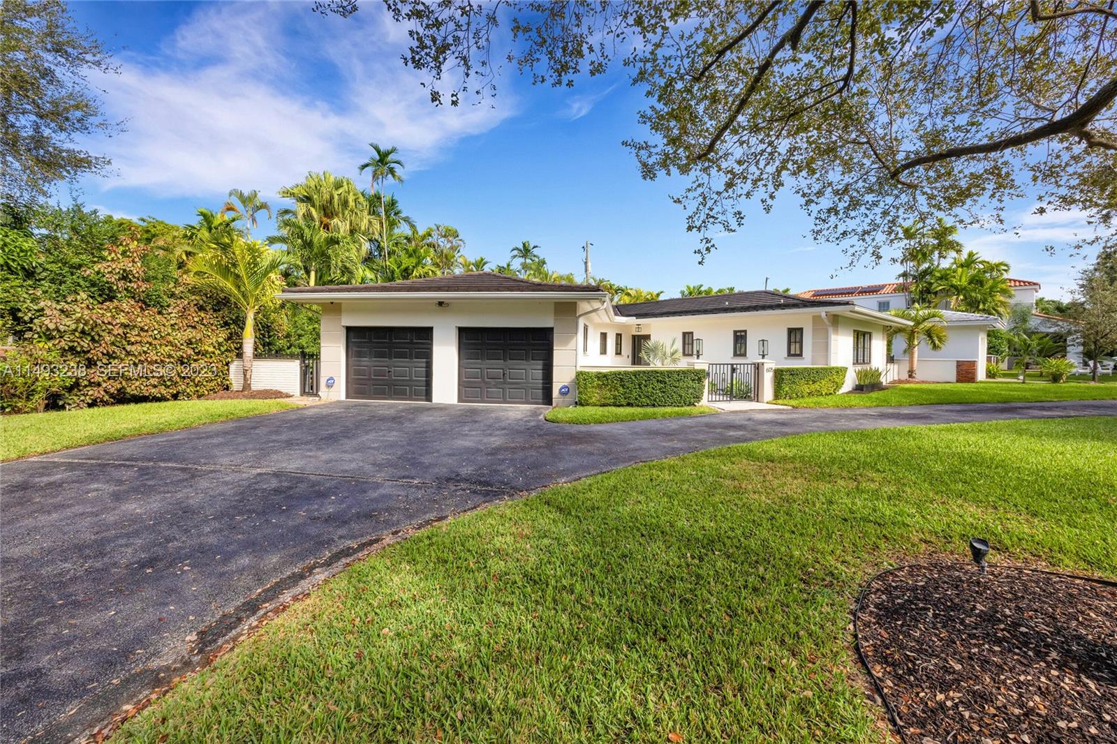 605 Blue Road Coral Gables, FL 33146 - Photo 3 of 34 a front view of a house with a garden