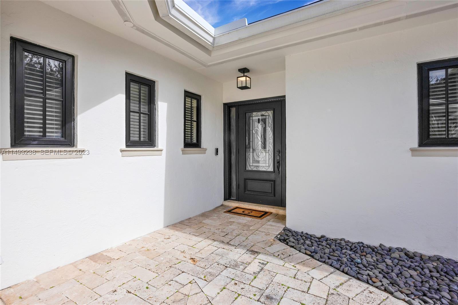 605 Blue Road Coral Gables, FL 33146 - Photo 6 of 34 a view of a hallway with windows