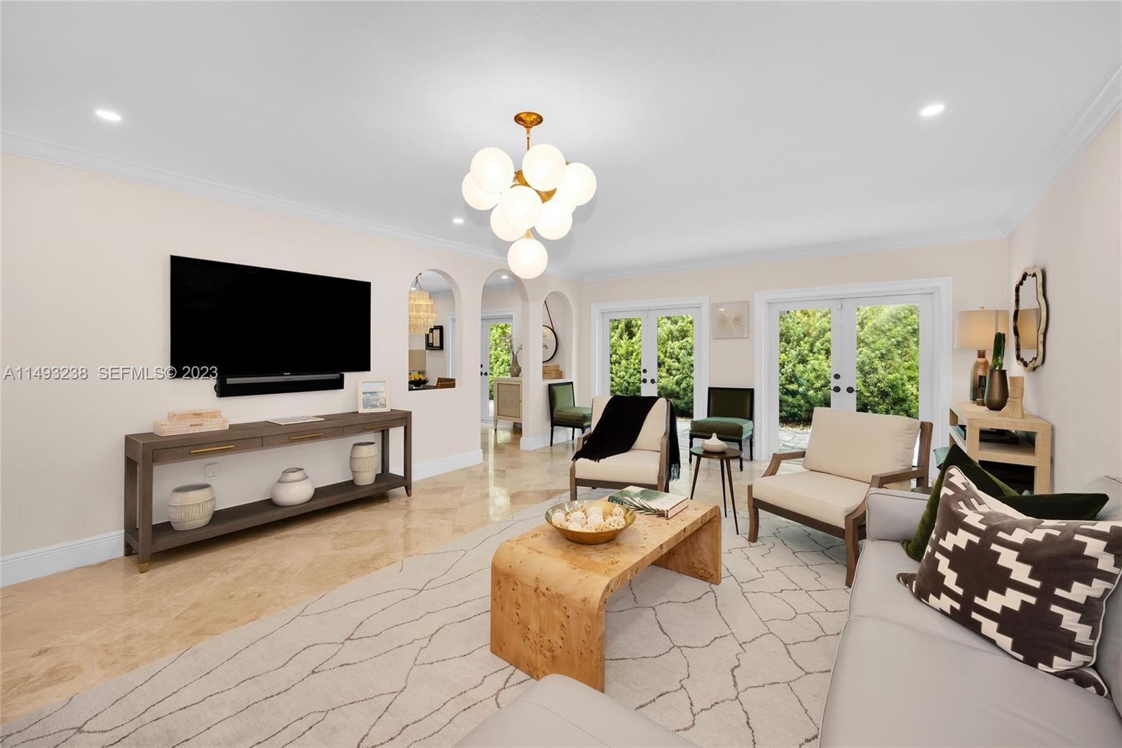 605 Blue Road Coral Gables, FL 33146 - Photo 9 of 34 a living room with furniture a flat screen tv and a window