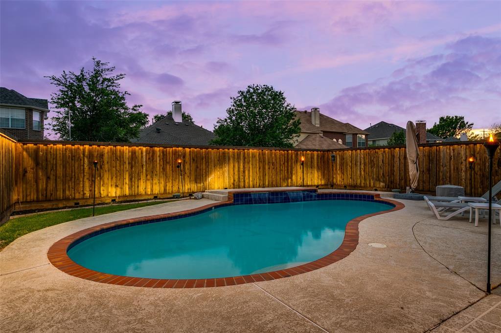 1509 Blue Mesa Road Carrollton, TX 75007 - Photo 33 of 35 a view of a swimming pool with lake and houses in the back