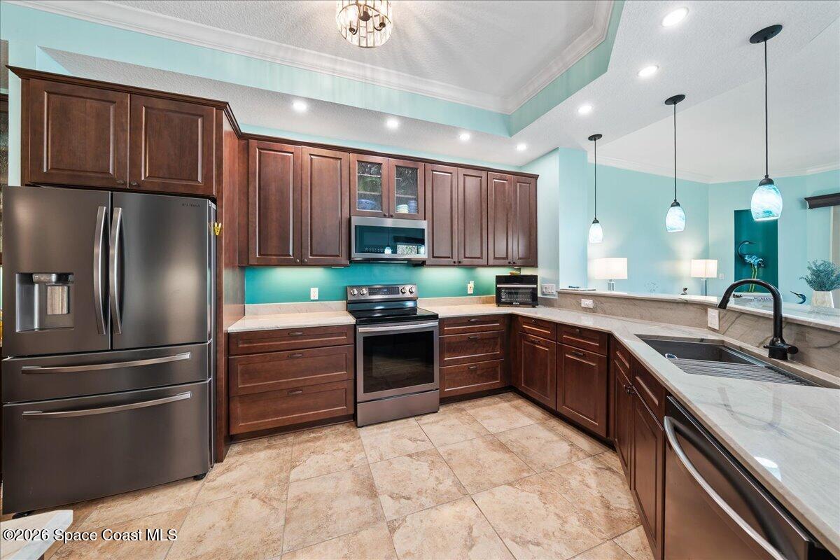 6005 Highway 1, Unit 101 Rockledge, FL 32955 - Photo 12 of 57 a kitchen with stainless steel appliances kitchen island granite countertop a refrigerator sink and cabinets