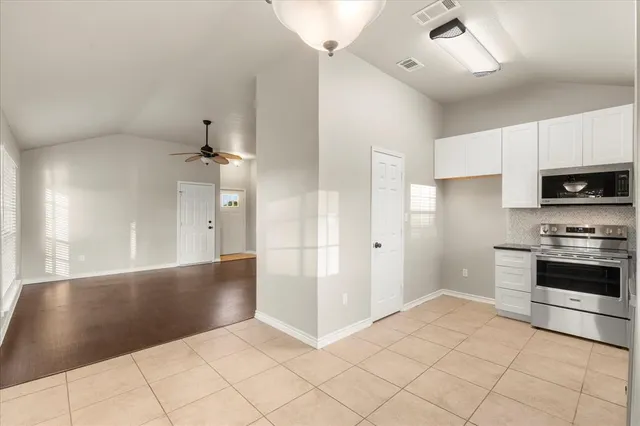 a view of a kitchen with a sink and a stove top oven