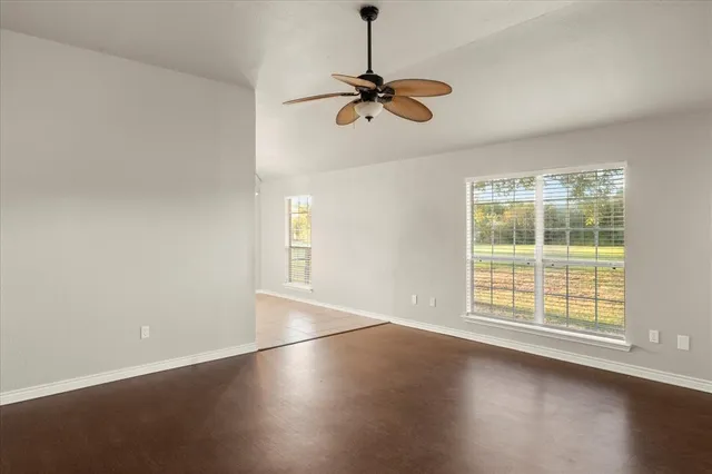a view of a room with wooden floor and windows