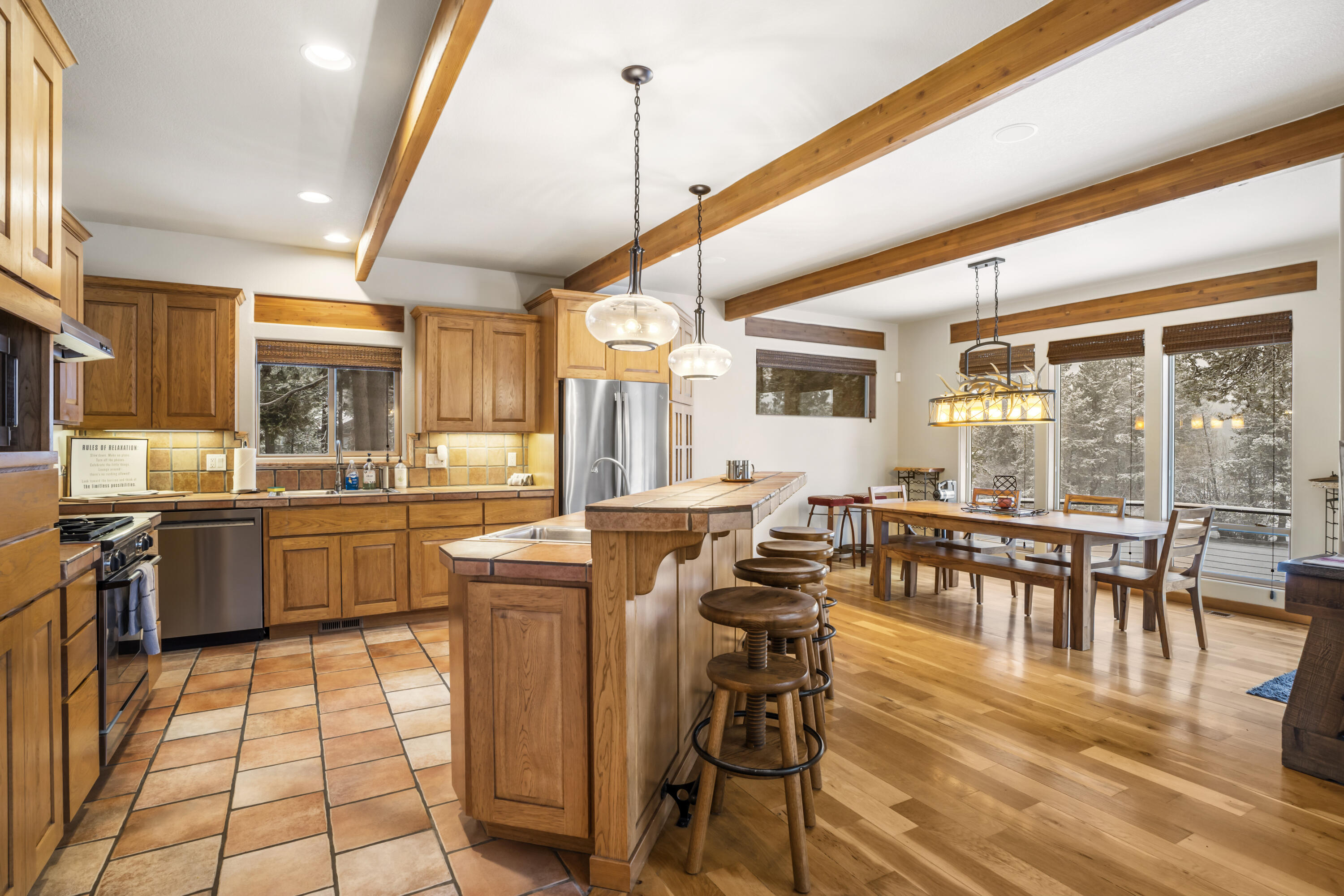 56065 Snow Goose Road Bend, OR 97707 - Photo 6 of 65 Exposed beams, Custom tile flooring and backsplash. Stainless steel appliances, Gas stove w/range hood and walk in Pantry. Brand new Dacor gas stove and oven. Chef's dream kitchen supplied with all you need for an amazing night in.