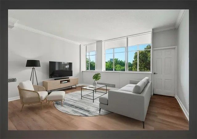 a living room with furniture a flat screen tv and a large window