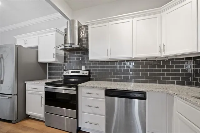 a kitchen with granite countertop white cabinets and white appliances