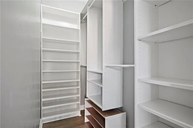 a view of walk in closet with empty racks