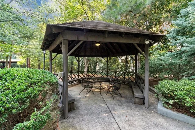 a view of patio with table and chairs under an umbrella