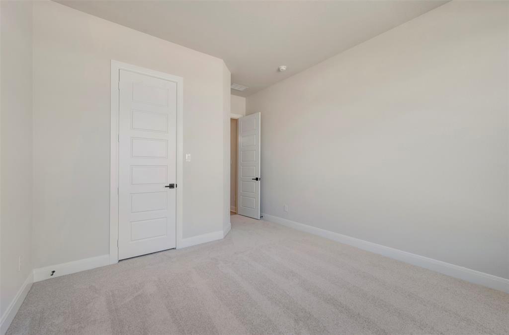 3575 Redbud Flower Trail Venus, TX 76084 - Photo 8 of 36 Spare room featuring light carpet and baseboards