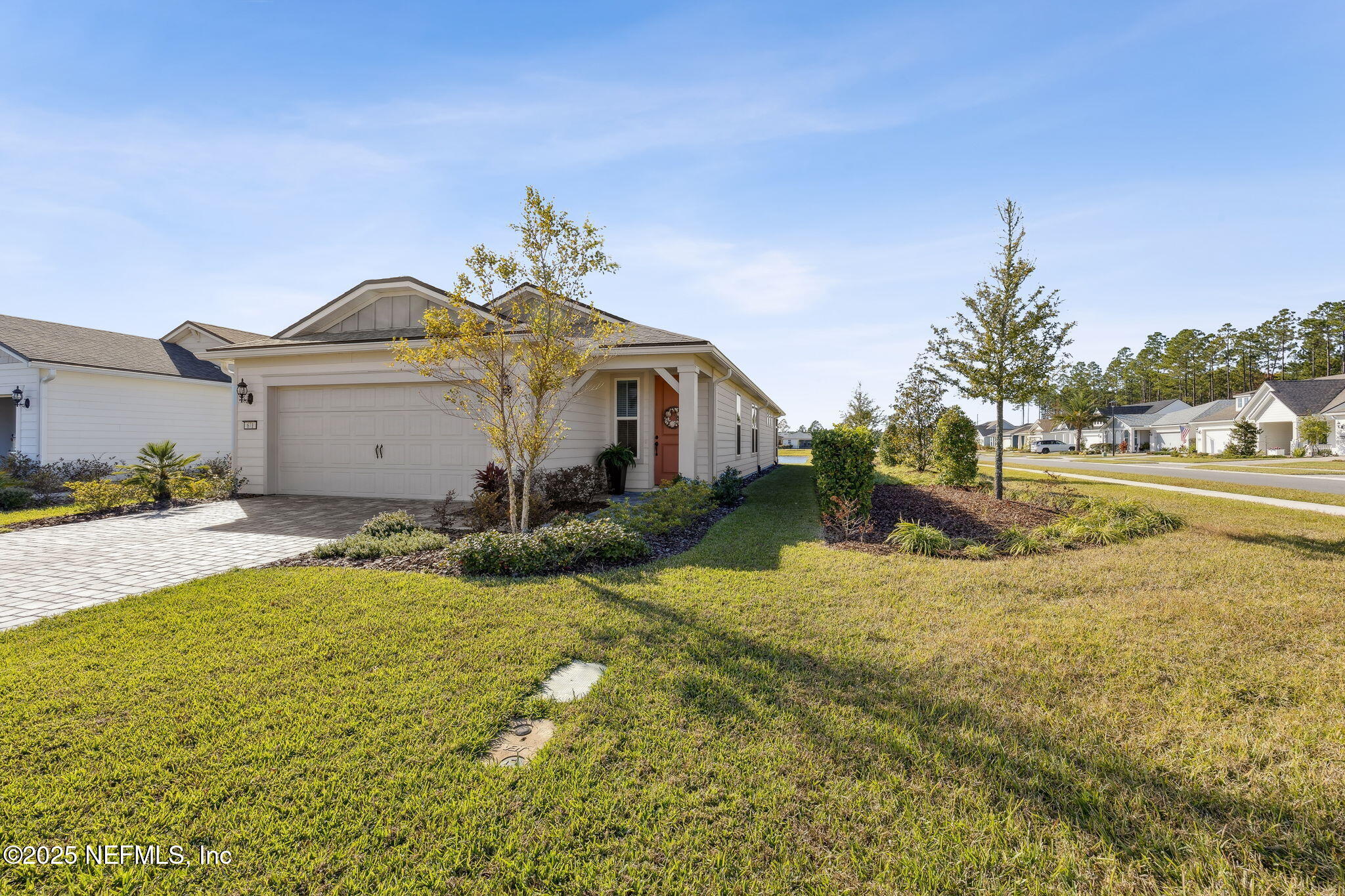 671 Jubilee Circle Yulee, FL 32097 - Photo 107 of 126 a front view of a house with a yard