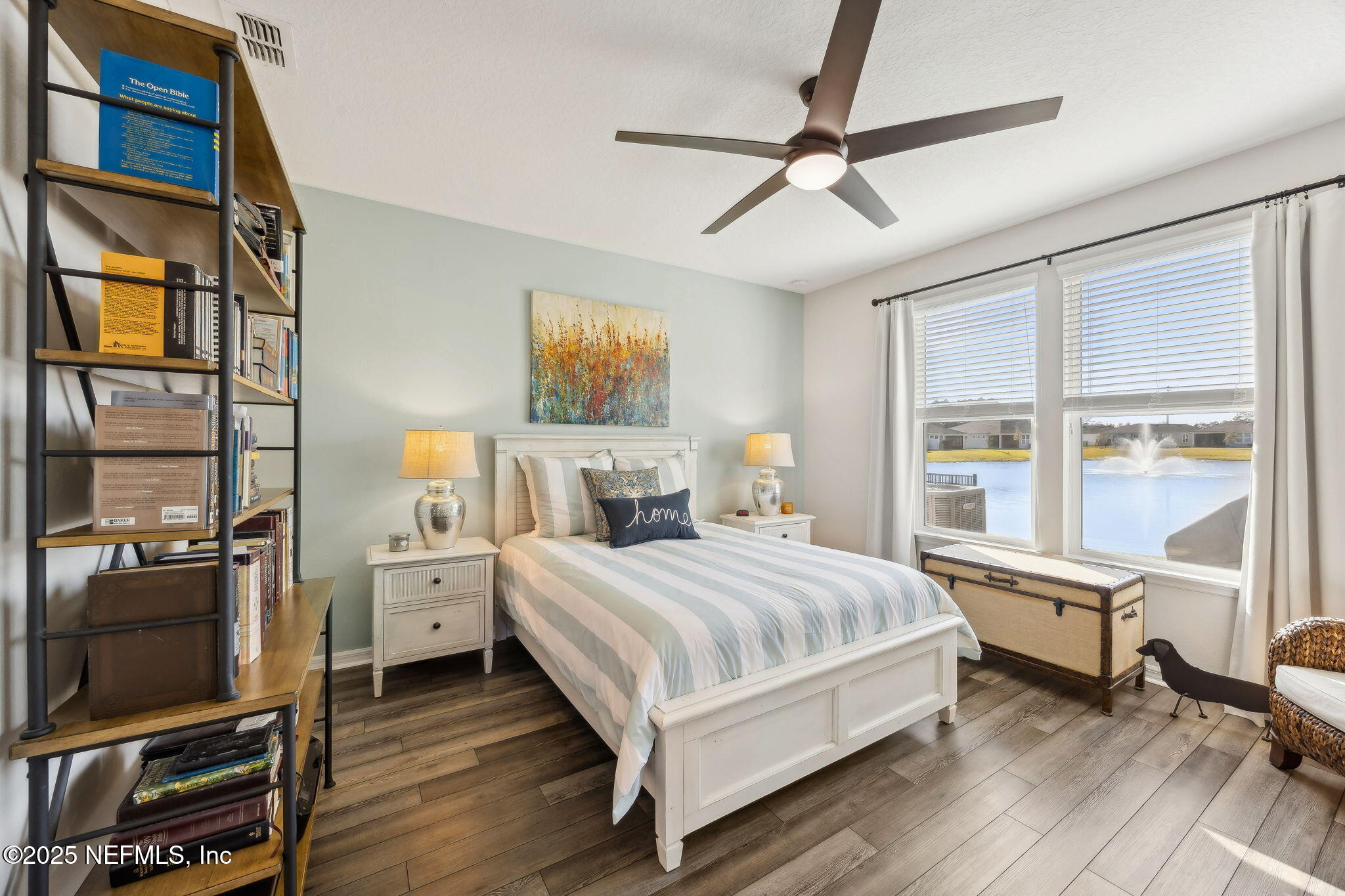 671 Jubilee Circle Yulee, FL 32097 - Photo 19 of 126 a bedroom with a bed and wooden floor